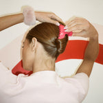 Big Effing Clip in Petunia model putting Big Effing Clip in Petunia in hair