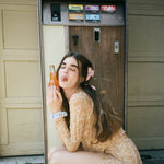 Big Effing Clip in Purple Shroom model sitting with Big Effing Clip in Purple Shroom in hair