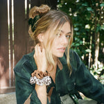 Big Effing Clip in Taurus Model with scrunchies on wrist wearing Big Effing Clip in Taurus in hair