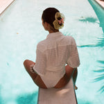 Cloud Scrunchie in Buttercup Silk Organza model sitting on diving board with Cloud Scrunchie in Buttercup Silk Organza in hair