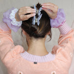 Cloud Scrunchie in Iris Silk Organza model wearing Cloud Scrunchies in Iris Silk Organza on wrists