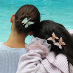 Papillon Clip in Bellini models wearing Papillon Clips in Bellini + La Mer