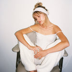 Pointelle Headband in Frosted Lilac model holding drink while wearing Pointelle Headband in Frosted Lilac