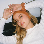 Pointelle Scrunchie in Spice closeup of model wearing Pointelle Scrunchie in Spice + Pointelle Headband in Spice