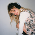 Sugar Muffs in Black Diamond model sitting while wearing Sugar Muffs in Black Diamond