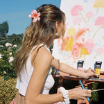 Super Bloom Clip in Guava model wearing Super Bloom Clip in Guava in hair + Sweet Dreams Scrunchie in Angel on wrist