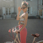 Super Bloom Clip in Wild Orchid model on bicycle with Super Bloom Clips in Wild Orchid in hair