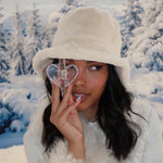 Cozy Clip In Snowed In model holding Cozy Clip In Snowed In while wearing Teddy Bucket Hat in Apres Ski