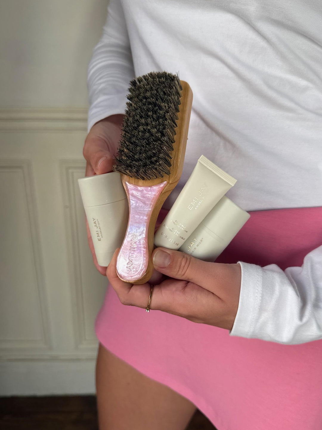 model sitting at table outside of cafe using Angelstick in hair