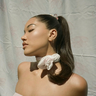 model wearing Sugar Blossom Head Scarf in Milk around her neck