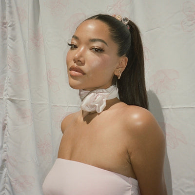 model wearing Sugar Blossom Head Scarf in Milk around her neck