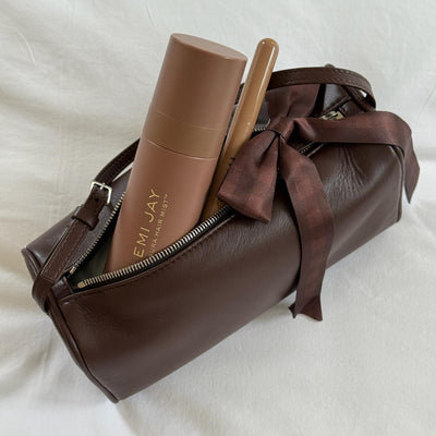 Aura Hair + Body Mist in Toasted Sugar with Bow Barrette in Fireside on purse.