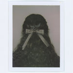 Polaroid of model wearing Bow Barrette in Toasted Sugar in hair.