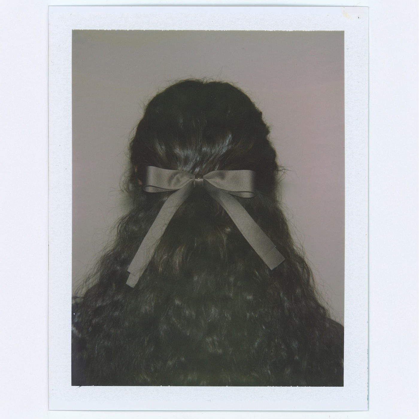 Polaroid of model wearing Bow Barrette in Toasted Sugar in hair.