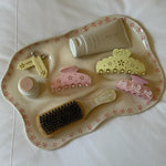 Cosa Ceramica x Emi Jay Vanity Tray in Pink Daisy with assorted emi jay hair care and accessories