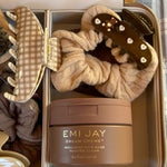 Cozy Scrunchie in Oat Latte Knit in vanity case with assorted emi jay hair care and accessories