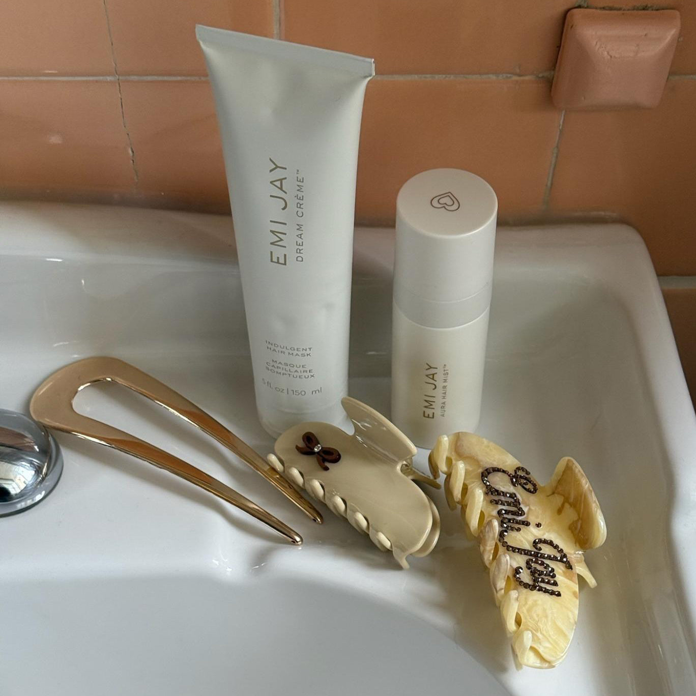 Assorted Emi Jay hair care and accessories sinkside.