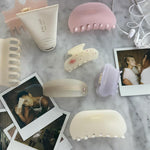 assorted emi jay hair care and accessories with polaroids and headphones