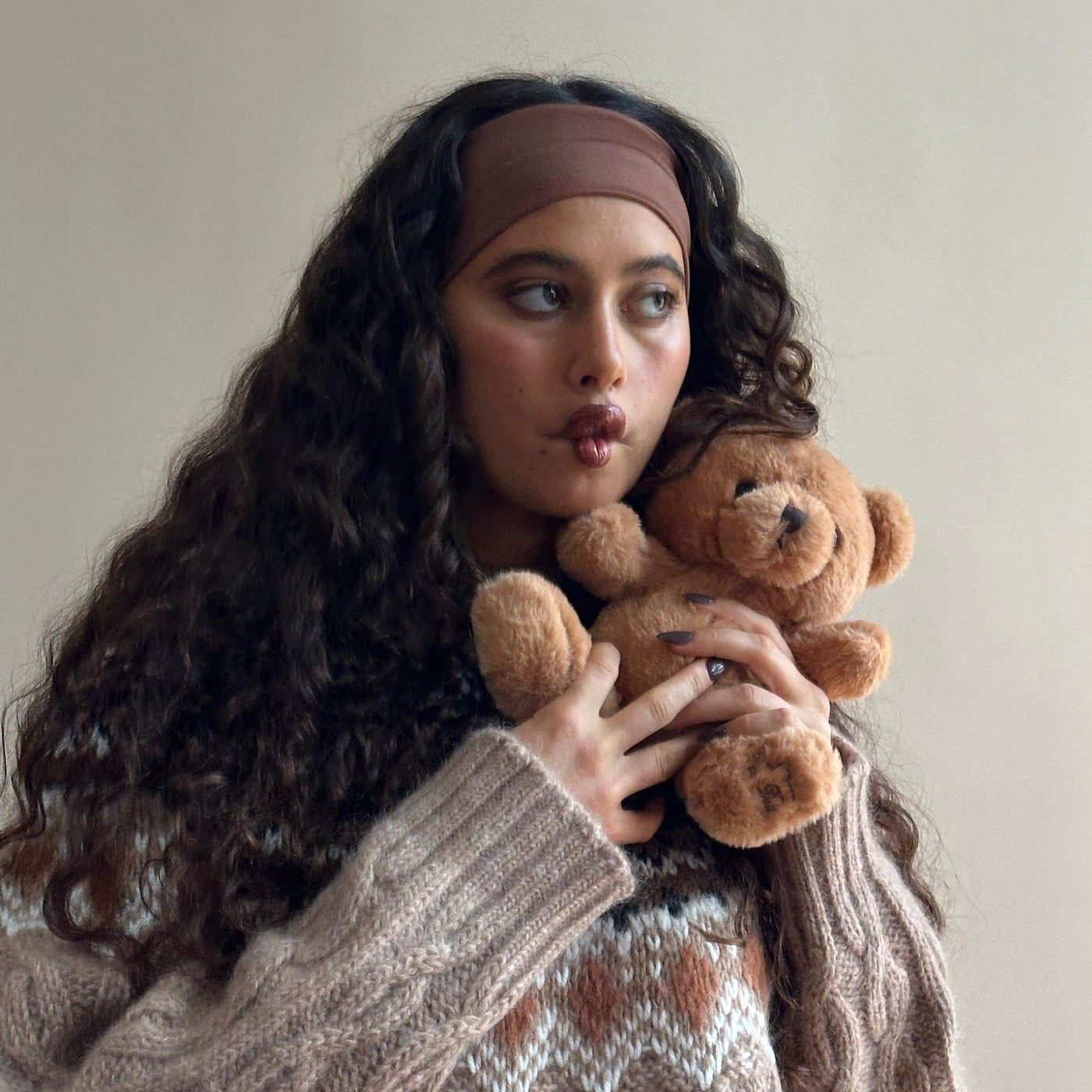 Model wearing Infinity Headband in Mousse while holding teddy bear.