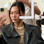 model with Limited Edition Angel Phone Grip on phone sitting while hair is styled 