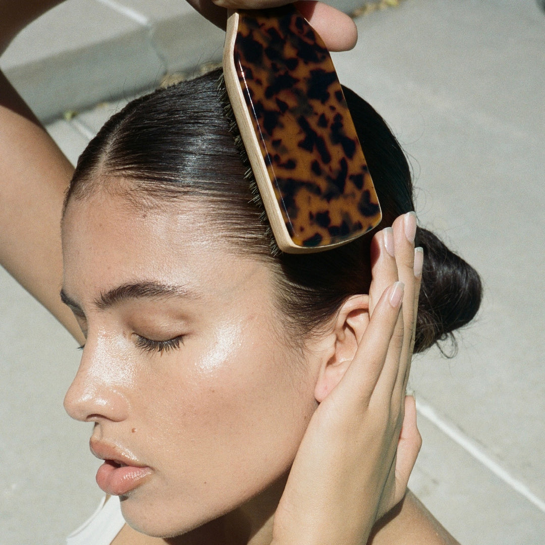 model brushing hair with Mini Boar Bristle Brush in Tortoise