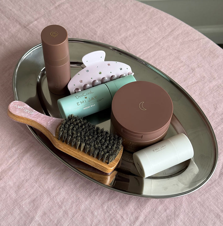 assorted emi jay hair care and accessories on silver tray