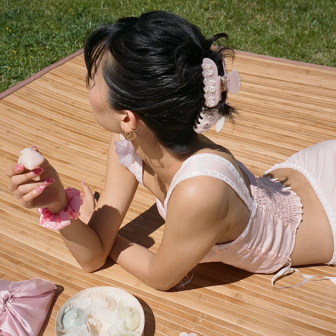 Model wearing Sweetheart Clip in Pink Pixie while eating a treat
