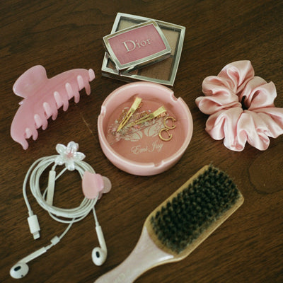 Angel Ashtray with big effing clip in pink sugar, popstar clips, rose tan silk scrunchie, headphones, baby clips, makeup, and mini boar brush in pink sugar