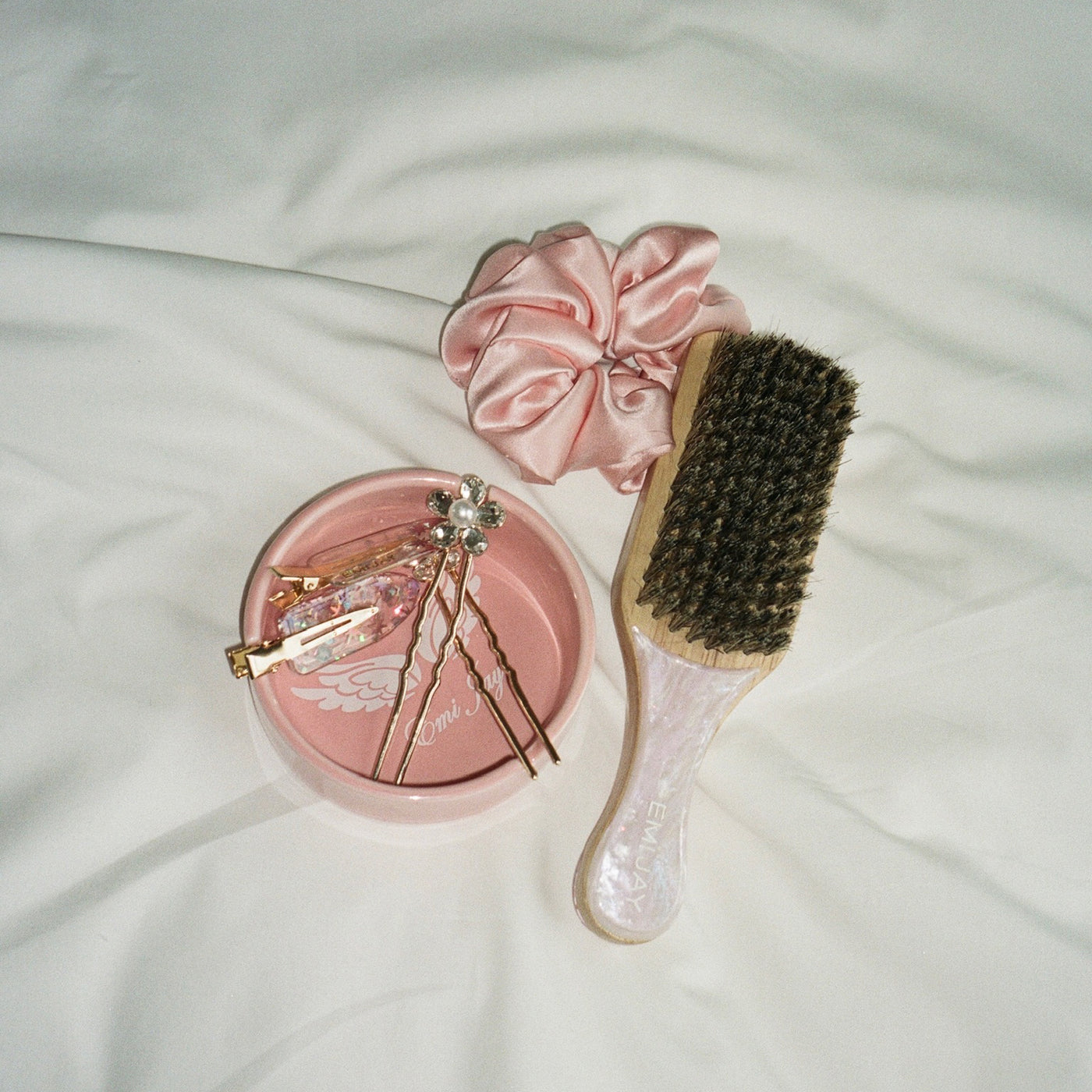 Angel Ashtray with hair pins, popstar clips, rose tan silk scrunchie, and pink sugar mini boar brush 