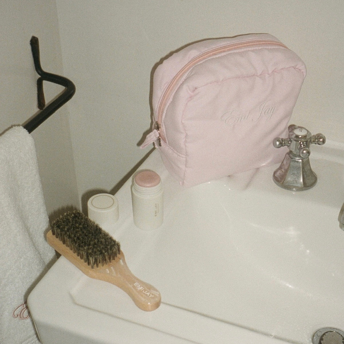 Angel Pouch in Rose Milk on bathroom sink next to mini boar brush in leche and angelstick