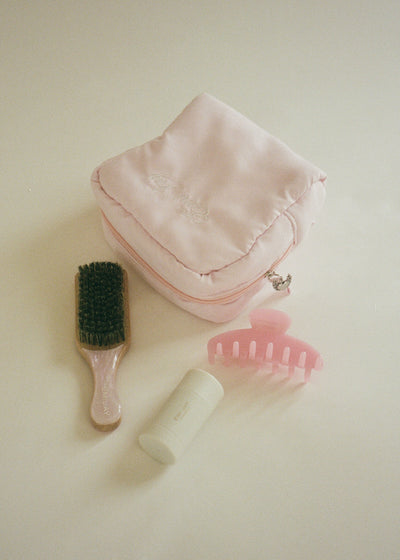angel pouch in rose milk next to big effing clip in cherub pink, angelstick, and boar bristle brush in pink sugar