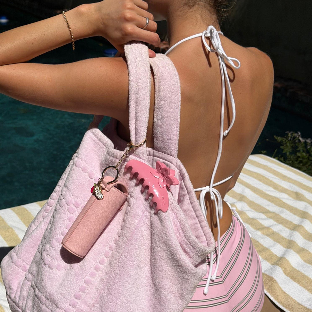 model with Aura Hair + Body Mist™ Keychain and big effing clip attached to purse