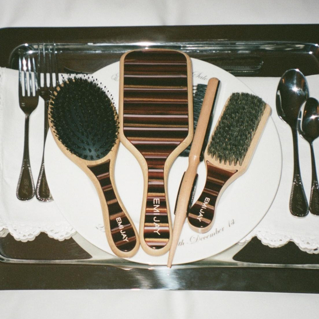 assorted nightcap brushes on dinner tray with utensils