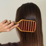 model brushing hair with Bamboo Paddle Brush in Nightcap