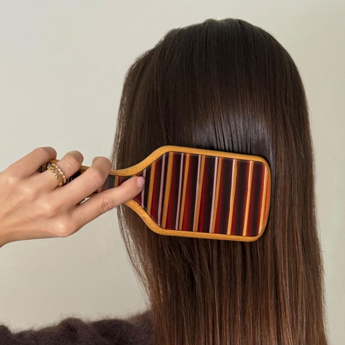 model brushing hair with Bamboo Paddle Brush in Nightcap