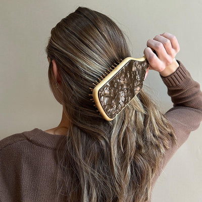 Model using Bamboo Paddle Brush in Toasted Sugar in hair.