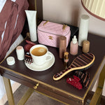 assorted hair care and accessories on side table with coffee