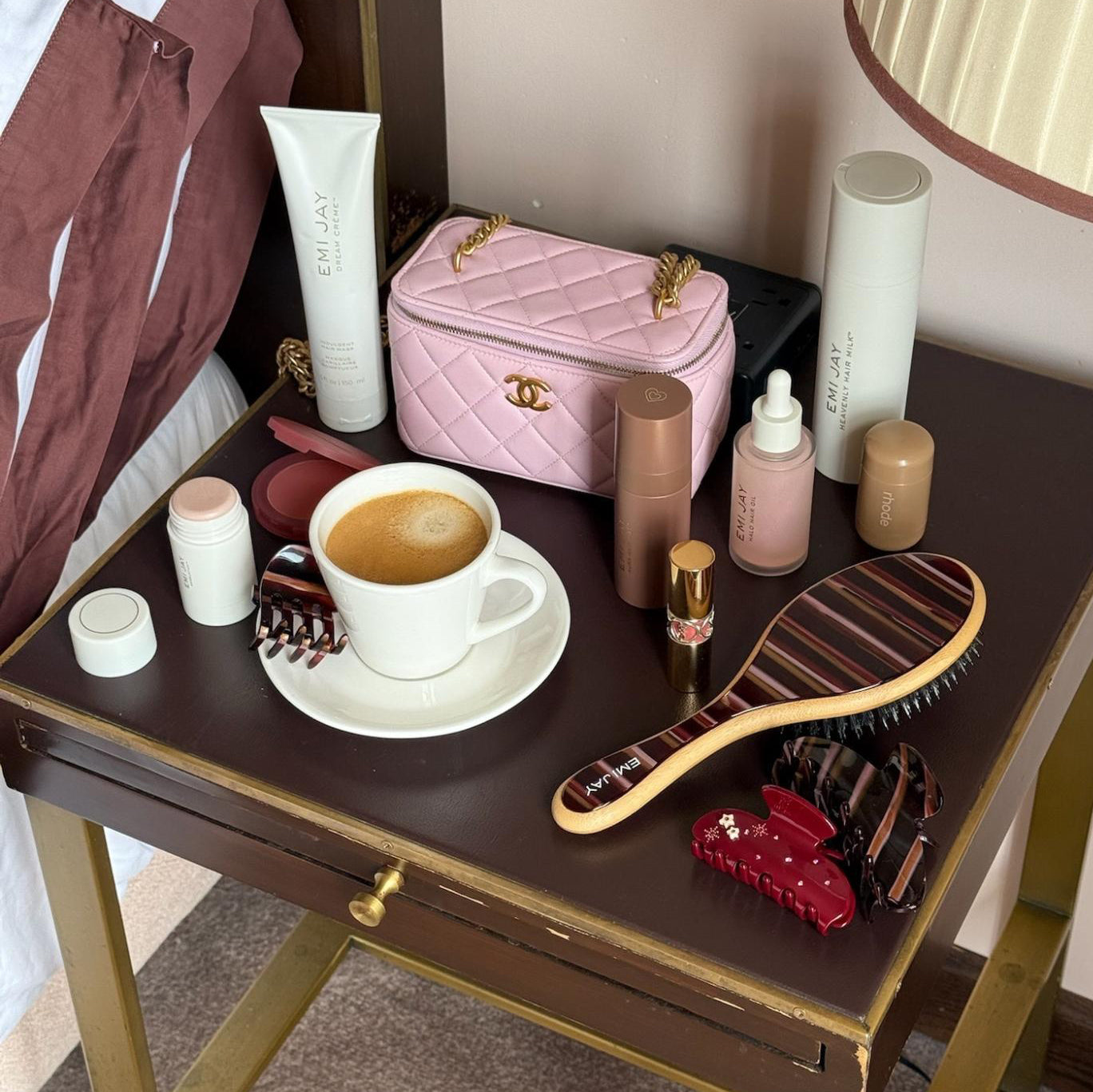 assorted hair care and accessories on side table with coffee
