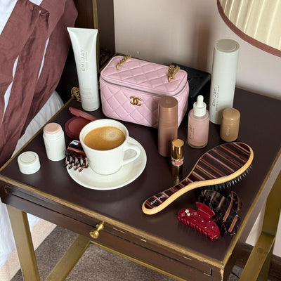 assorted hair care and accessories on side table with coffee
