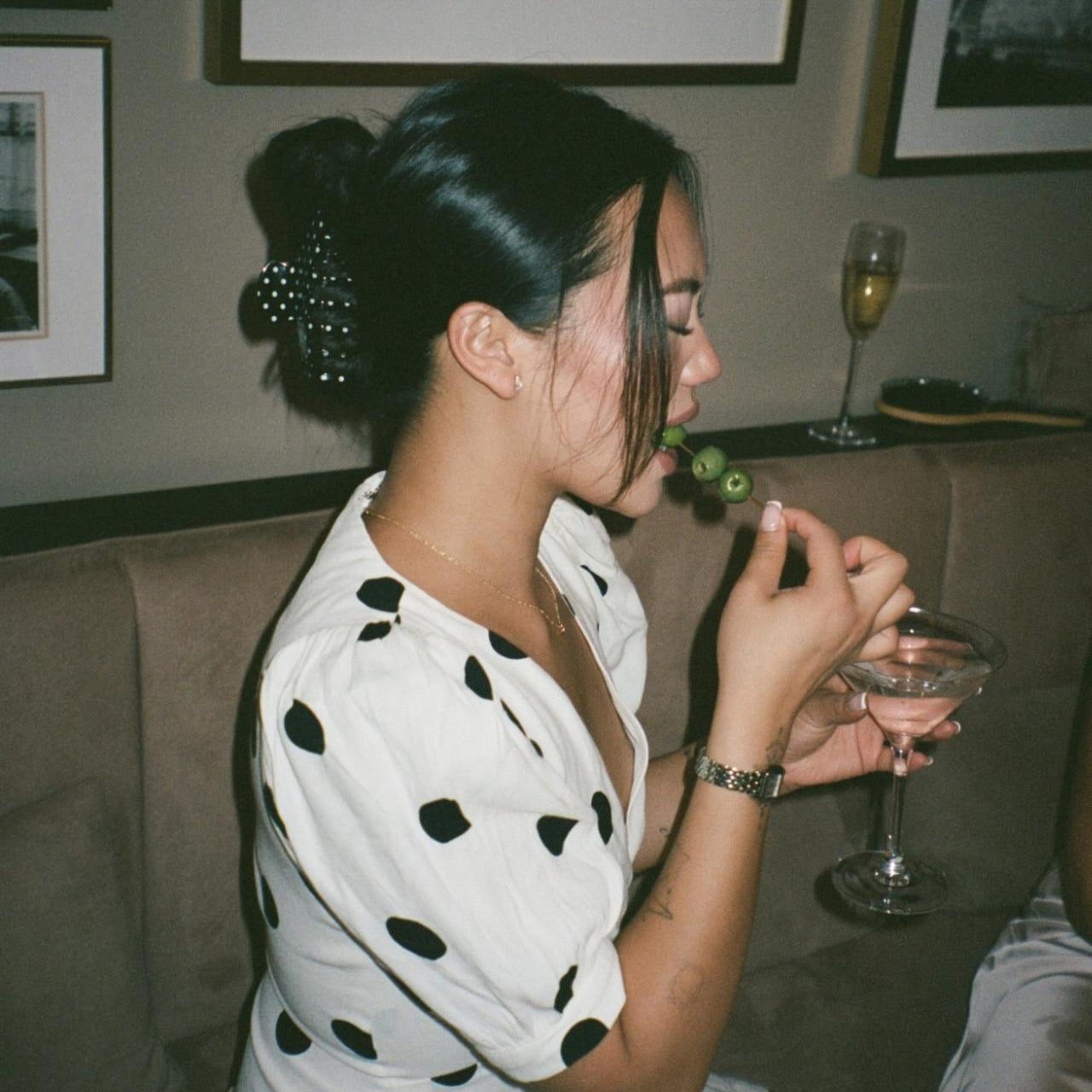 model earing olives from martini while wearing Big Effing Clip in Noir Polka Dot in hair