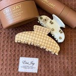 assorted emi jay hair care and accessories on towel