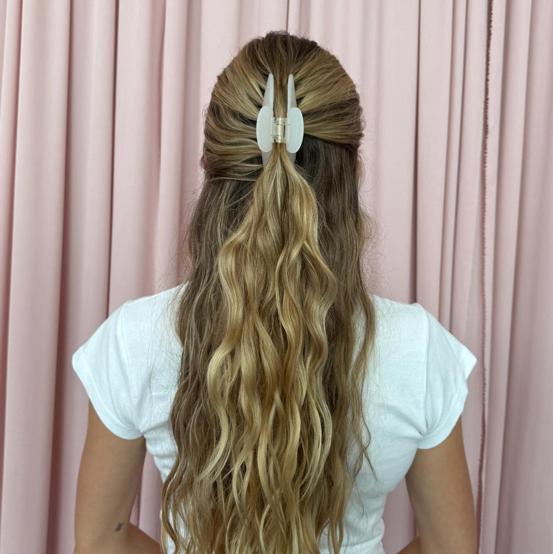 model standing in front of pink curtain with Big Effing Clip in Morning Angel in hair