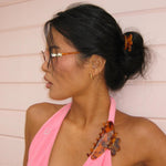 model wearing Big Effing Clip in Tortoise Hibiscus 