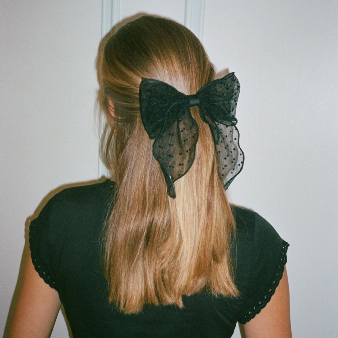 model wearing Bow Barrette in Sheer Noir in hair