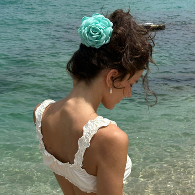model wearing Camellia Clip in Sea Salt