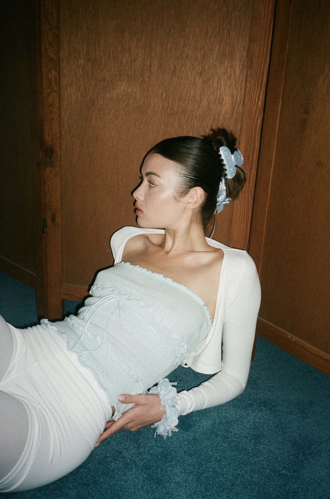 model laying on blue carpet wearing Crème de la Crème sweetheart clip and scrunchies 