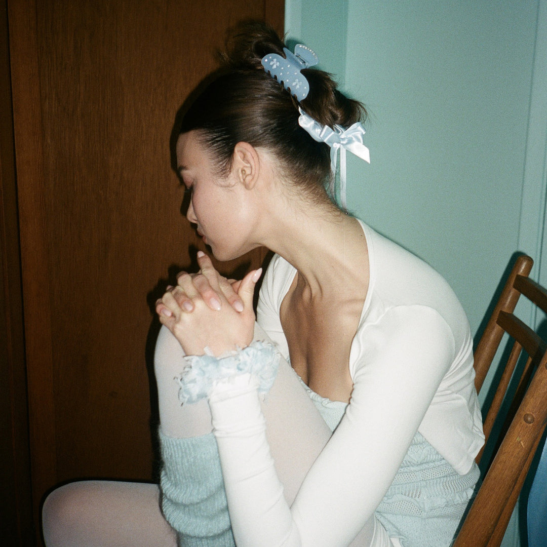 model looking away while wearing Darling Scrunchie in Baby Blue in hair