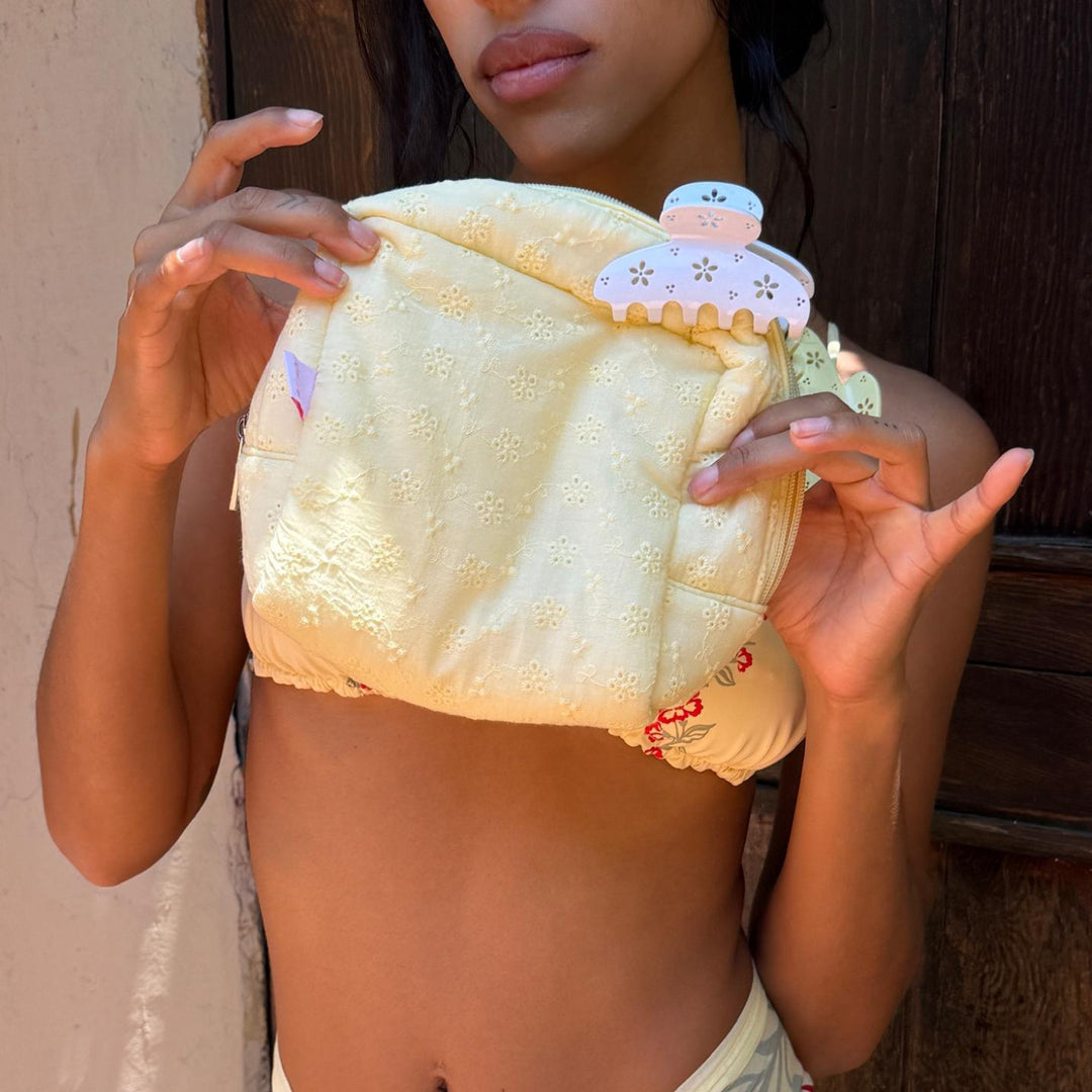 model holding Eyelet Pouch in Citrine with clips attached