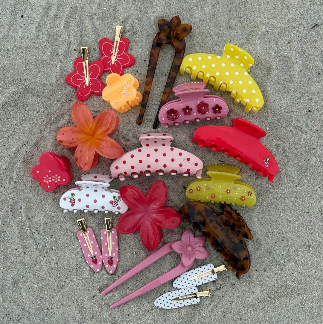 assorted emi jay hair accessories on sand