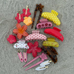 assorted emi jay hair accessories on sand